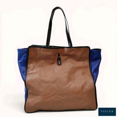 an image of a brown and blue handbag sitting on top of a white surface