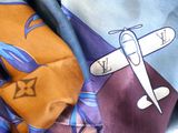 a close up of a neck tie with a plane on it