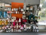 many different colored vases on the shelves in the store
