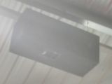 ceiling mounted air conditioner in a garage with a white roof