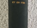 a black book with gold writing on it sitting on a table