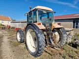 a tractor that is parked in the dirt