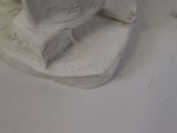 a white statue of a bird on a white surface