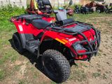 an image of a red four wheeler atv parked in the grass