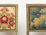 pair of painted chairs with floral designs on them against a white background