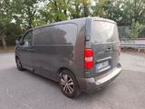 a grey van that is parked on the side of the road
