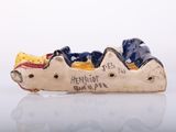 a figurine of a dog that is sitting in a boat