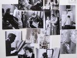 black and white photograph of a bunch of pictures on a wall