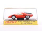 a red model of a car in a clear case