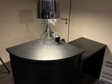a desk with a lamp on top of it in a room