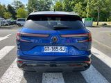 the rear end of a blue volkswagen suv parked in a parking lot