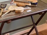 a small table with a lot of brushes on it