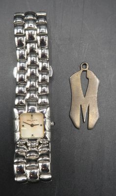 an image of a watch and a keychain sitting on a table