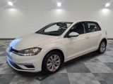 a white volkswagen golf is parked in a room with checkered floor