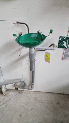 a green sink sitting on the side of a wall
