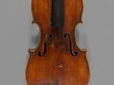 an old violin with a bow on a gray background
