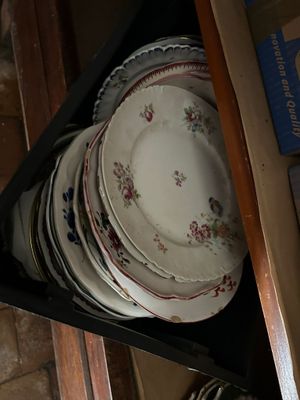 a lot of plates that are stacked up in a drawer