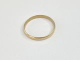 a gold ring on a white surface