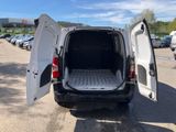 a white van with its door open in a parking lot