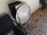 a white toilet sitting on a metal stand next to a radiator