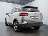 the rear end of a silver citrole parked in a garage