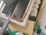 a box full of items sitting on the floor next to a stove