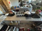 a view of a kitchen with a lot of dishes on the counter