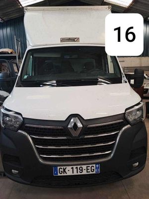 a white van parked in a garage with a number 16 on the front