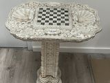 a marble table with a chess board on it