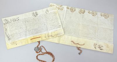 an old document with a chain attached to it next to a necklace