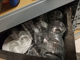 a drawer full of empty glasses and plates