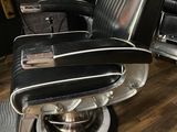 a black and white barber chair in a barber shop