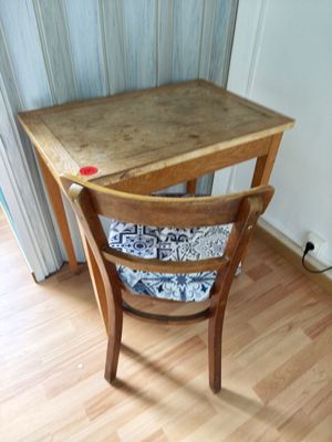 a small wooden table with a wooden chair next to it