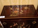 a wooden chest with a floral design on it