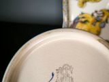 a close up of a vase with a blue and yellow design