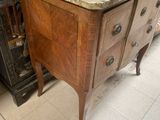a marble top dresser in a room with a painting on the wall behind it