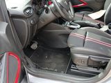 the interior of a car with red trims and a steering wheel