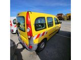 yellow van parked in a parking lot with other vehicles in the background