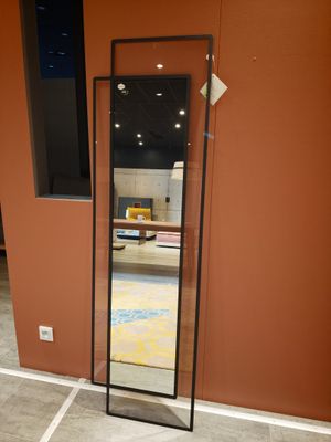 a large mirror in the corner of a room