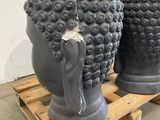 two black vases sitting on a pallet in a room
