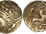 a close up of two silver coins with designs on them