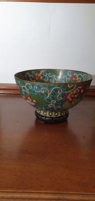 a bowl that is sitting on a table next to a vase