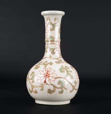 an image of a white vase with green and red designs on it