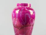 purple glass vase with a floral design on the outside of it