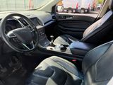 l'intérieur d'une voiture avec des sièges en cuir noir et un volant