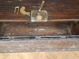 an old wooden box with a key and a bird on it