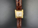 an image of a close up of a wrist watch on a table