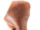 a wooden sculpture of a man ' s head on a white surface