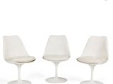 three white tulip chairs and a table on a white background