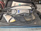 a case with a cord and a tool in it